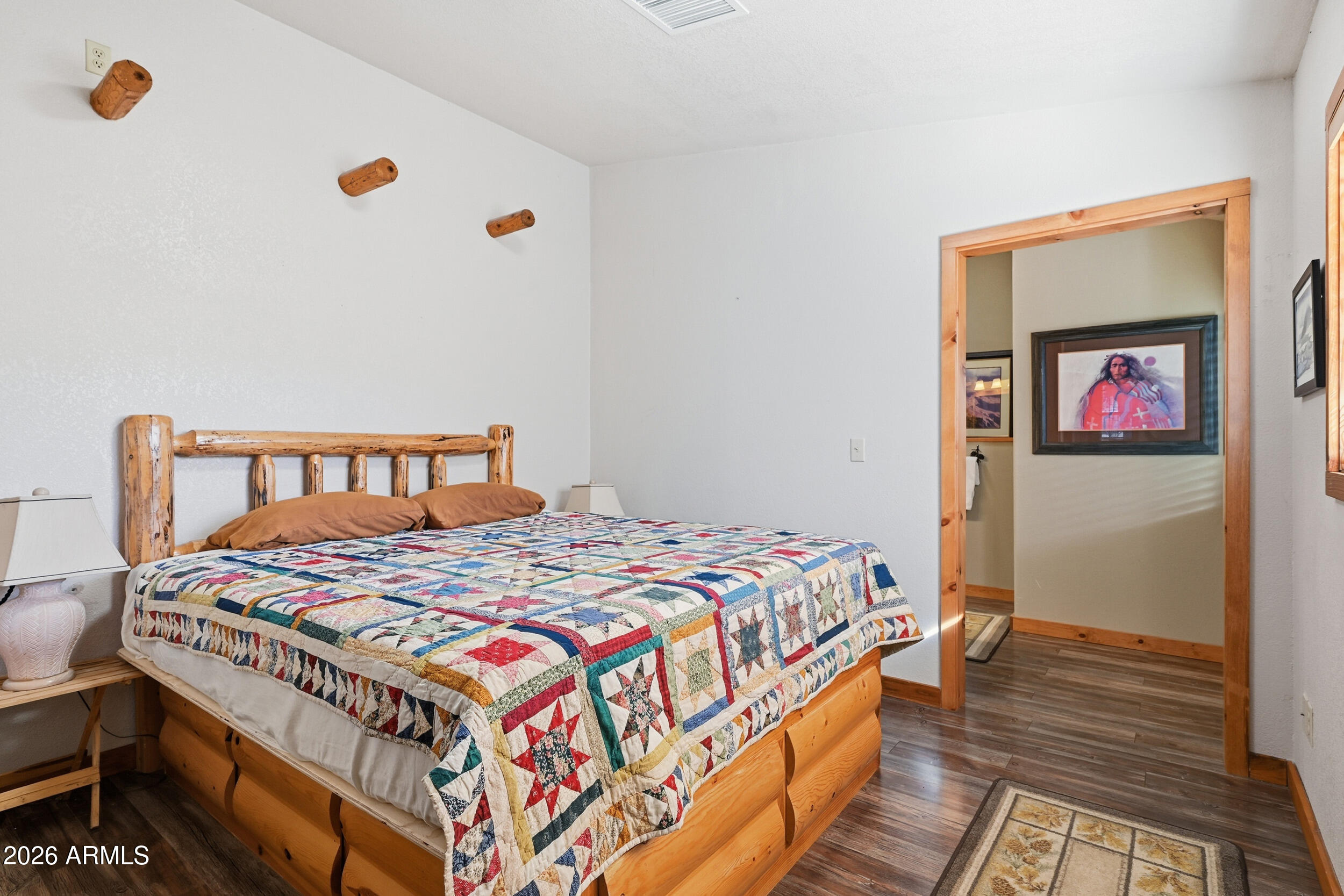 3933 Highway 260, Unit SP 256 Star Valley, AZ 85541 - Photo 8 of 28 a bedroom with a bed and wooden floor