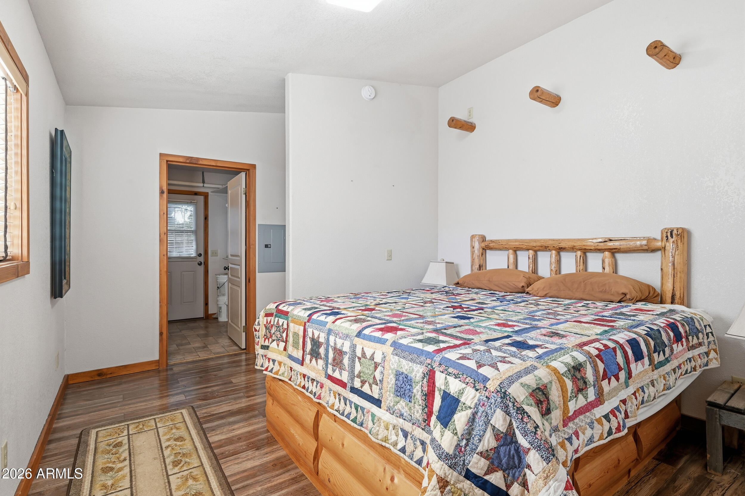 3933 Highway 260, Unit SP 256 Star Valley, AZ 85541 - Photo 9 of 28 a bedroom with a bed and wooden floor