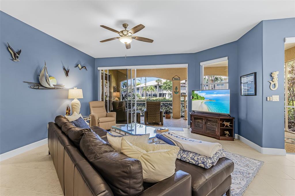 3312 Sunset Key Circle, Unit B Punta Gorda, FL 33955 - Photo 13 of 37 a living room with furniture and a large window