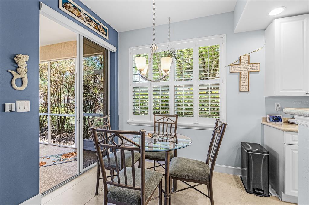 3312 Sunset Key Circle, Unit B Punta Gorda, FL 33955 - Photo 15 of 37 a view of a dining room with furniture large windows and backyard