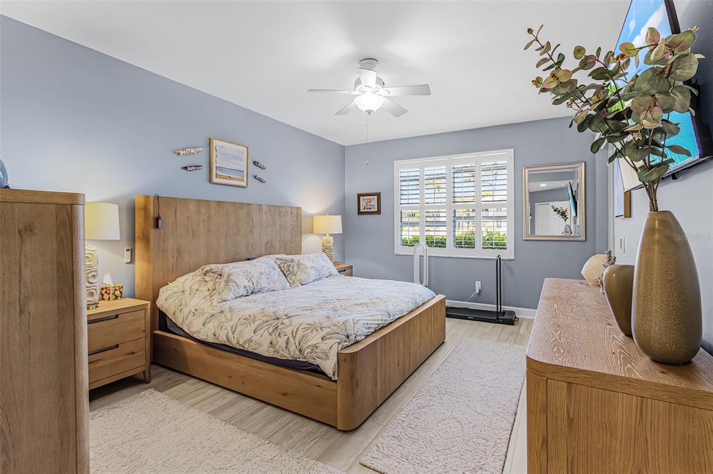 3312 Sunset Key Circle, Unit B Punta Gorda, FL 33955 - Photo 18 of 37 a spacious bedroom with a bed and a chandelier