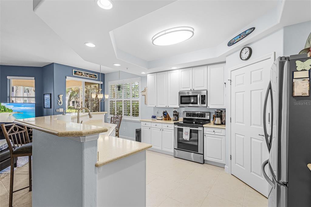 3312 Sunset Key Circle, Unit B Punta Gorda, FL 33955 - Photo 8 of 37 a kitchen with stainless steel appliances granite countertop a sink and a refrigerator