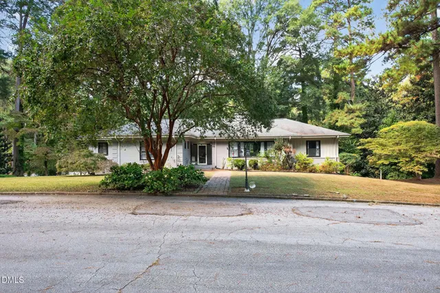 a front view of a house with a yard and a garage
