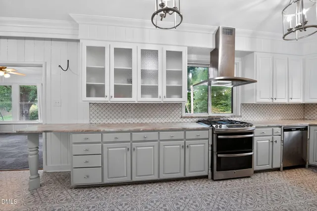 a kitchen with stainless steel appliances granite countertop a stove and a sink