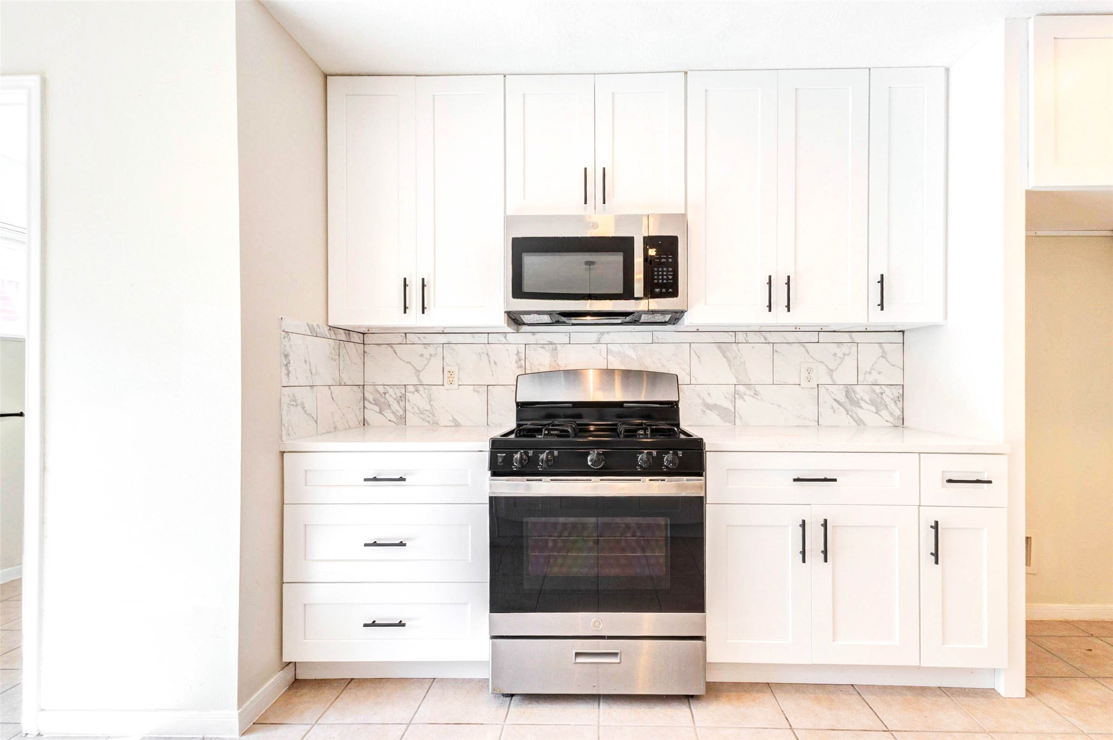 5318 Cilantro Lane Baytown, TX 77521 - Photo 12 of 45 a kitchen with stainless steel appliances white cabinets and a stove top oven