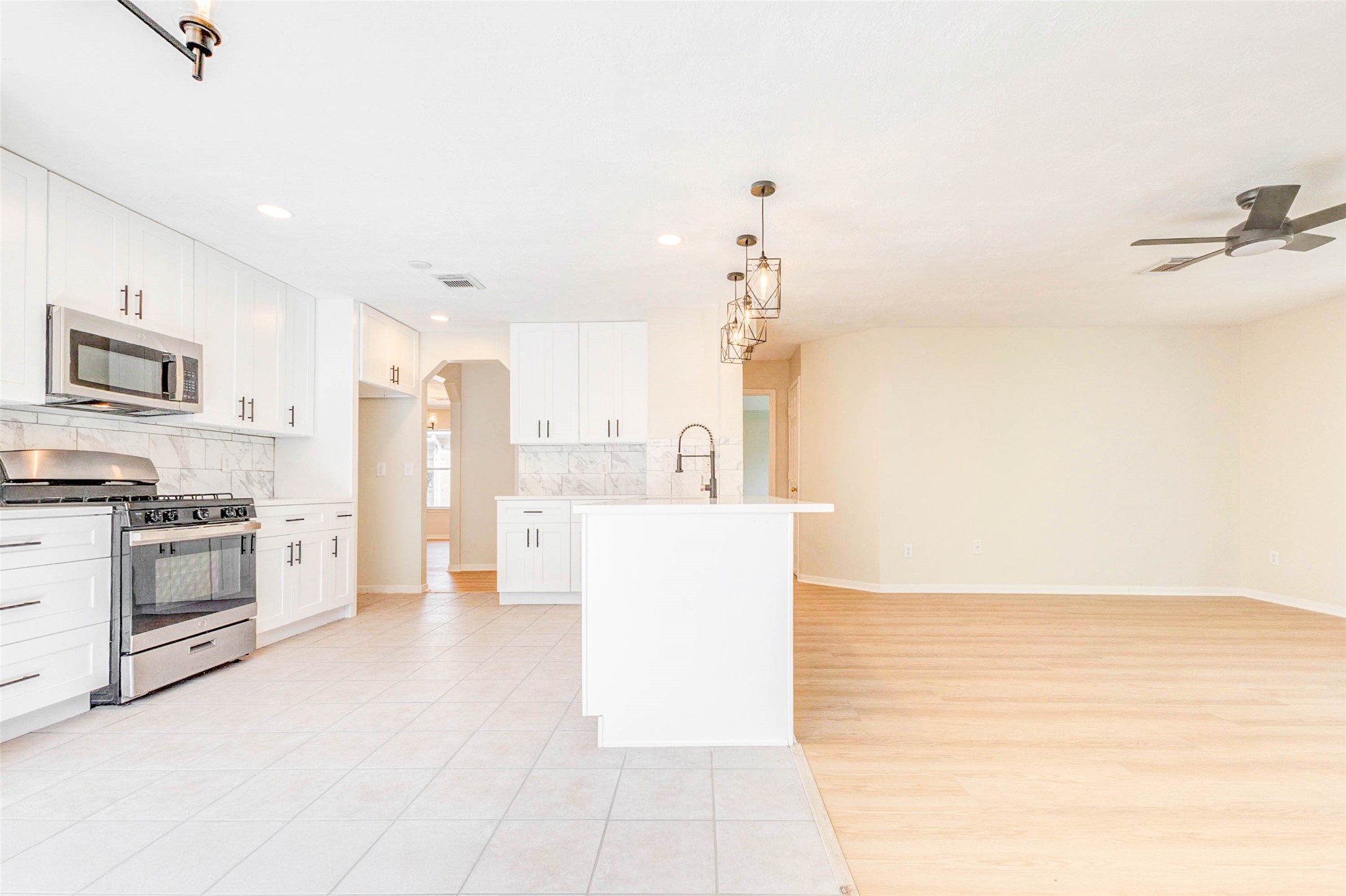 5318 Cilantro Lane Baytown, TX 77521 - Photo 15 of 45 a kitchen with stainless steel appliances a refrigerator and a stove top oven