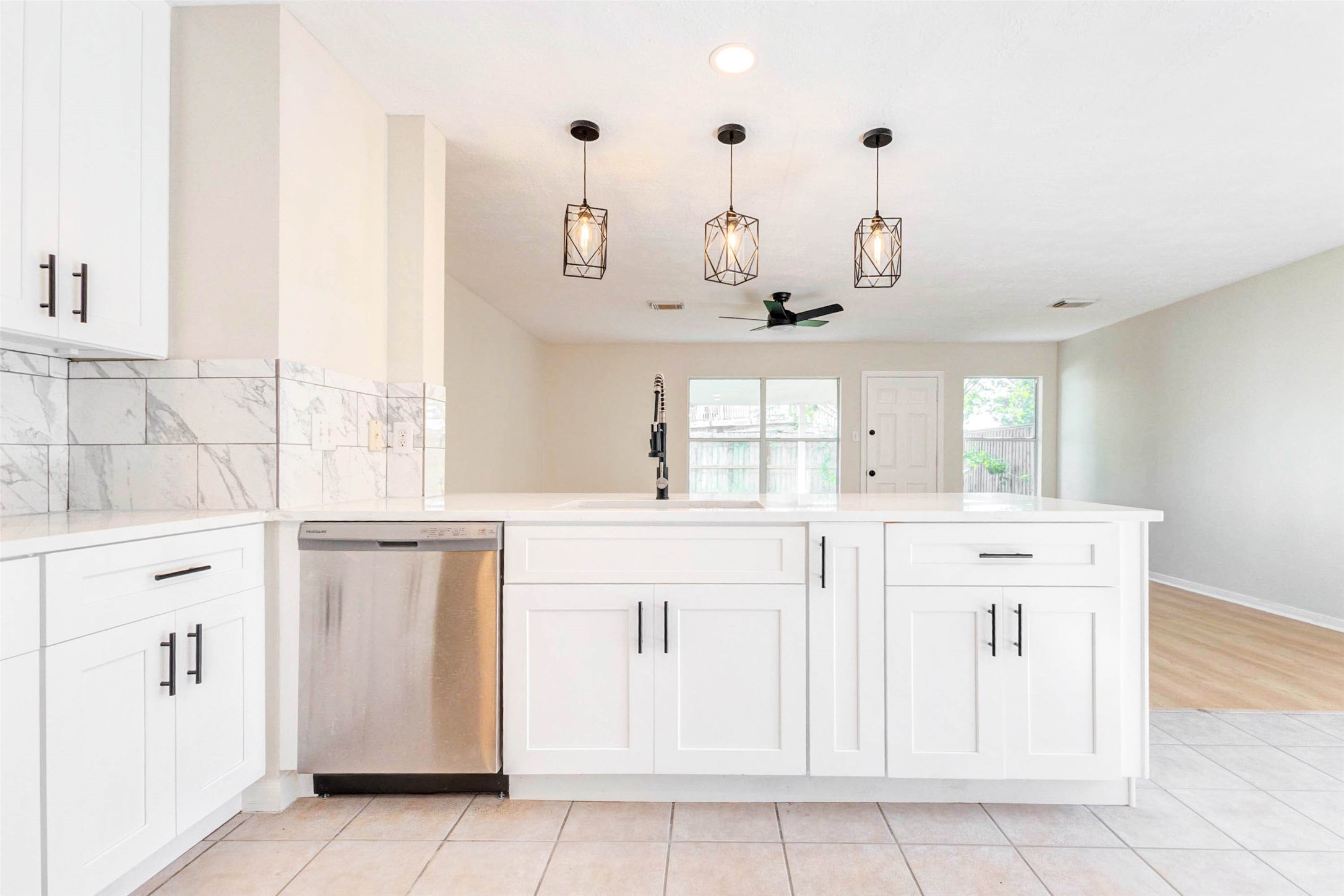 5318 Cilantro Lane Baytown, TX 77521 - Photo 21 of 45 a kitchen with white cabinets and window