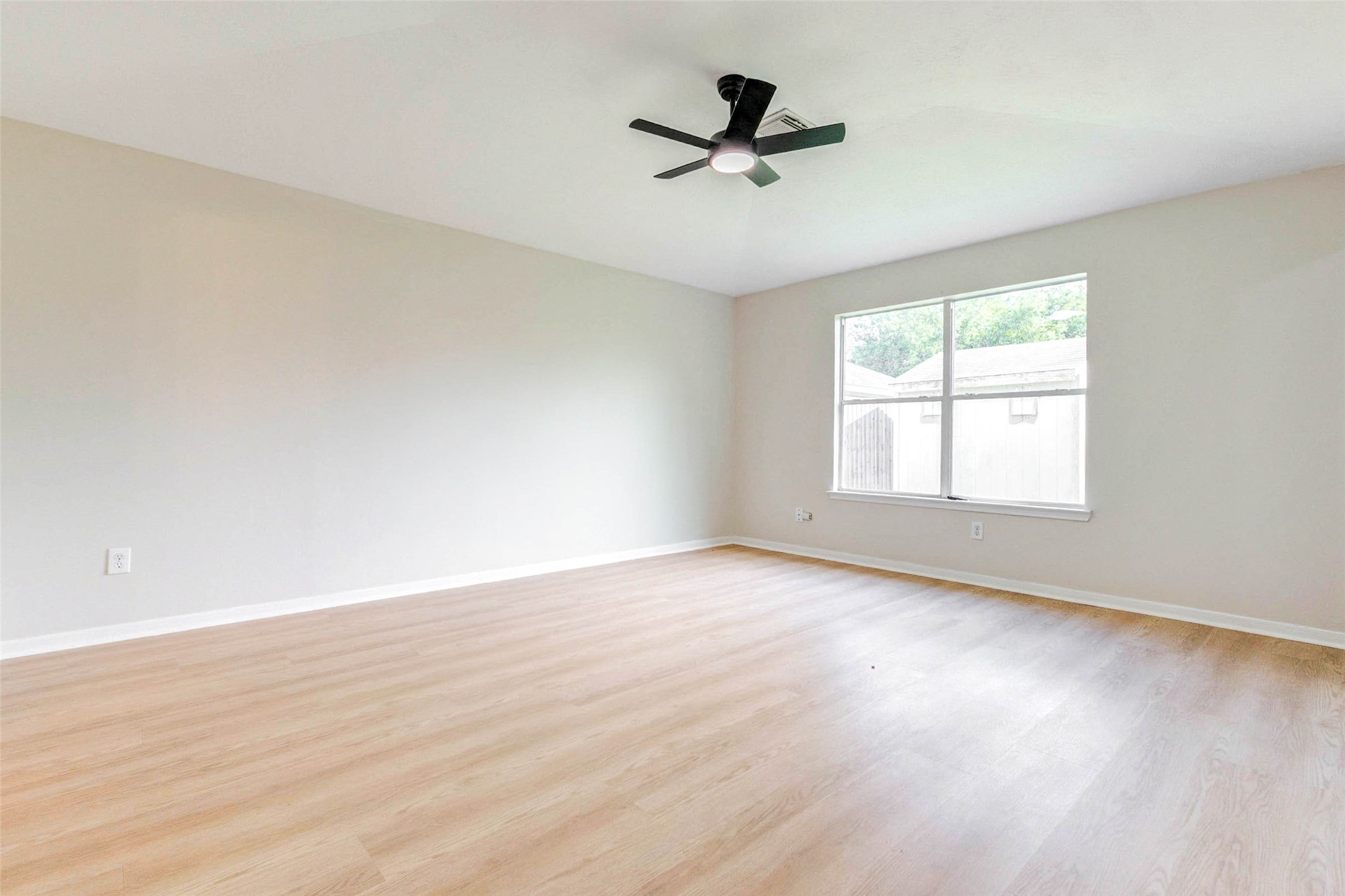5318 Cilantro Lane Baytown, TX 77521 - Photo 23 of 45 a view of empty room with wooden floor and fan