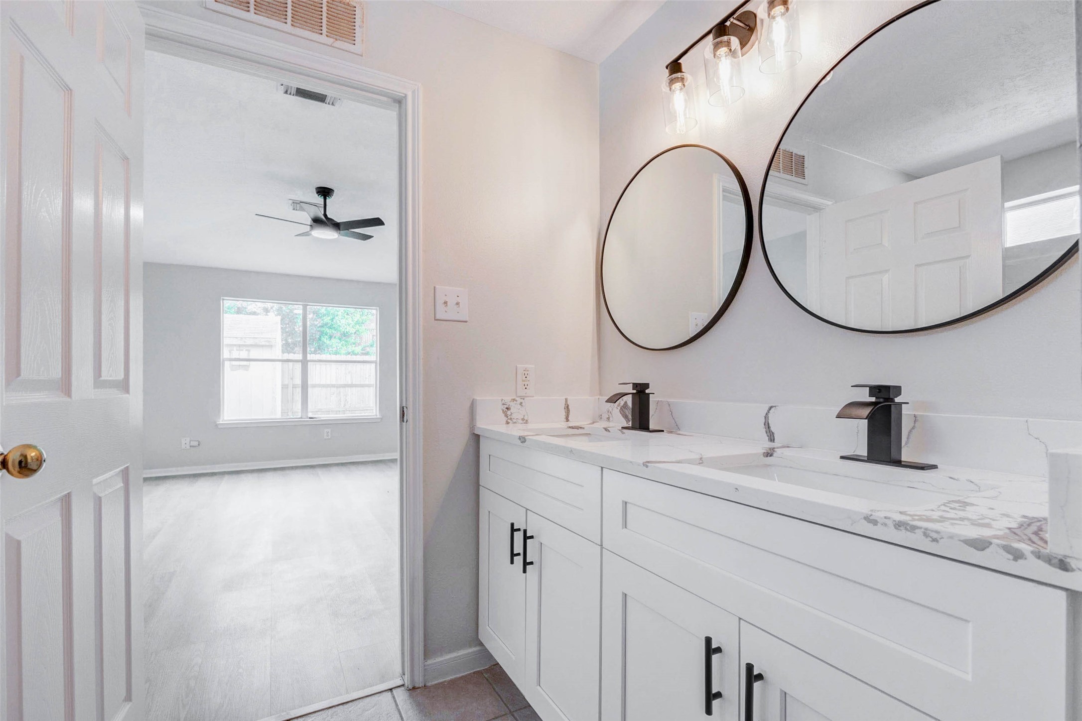 5318 Cilantro Lane Baytown, TX 77521 - Photo 27 of 45 a bathroom with a granite countertop sink and a mirror
