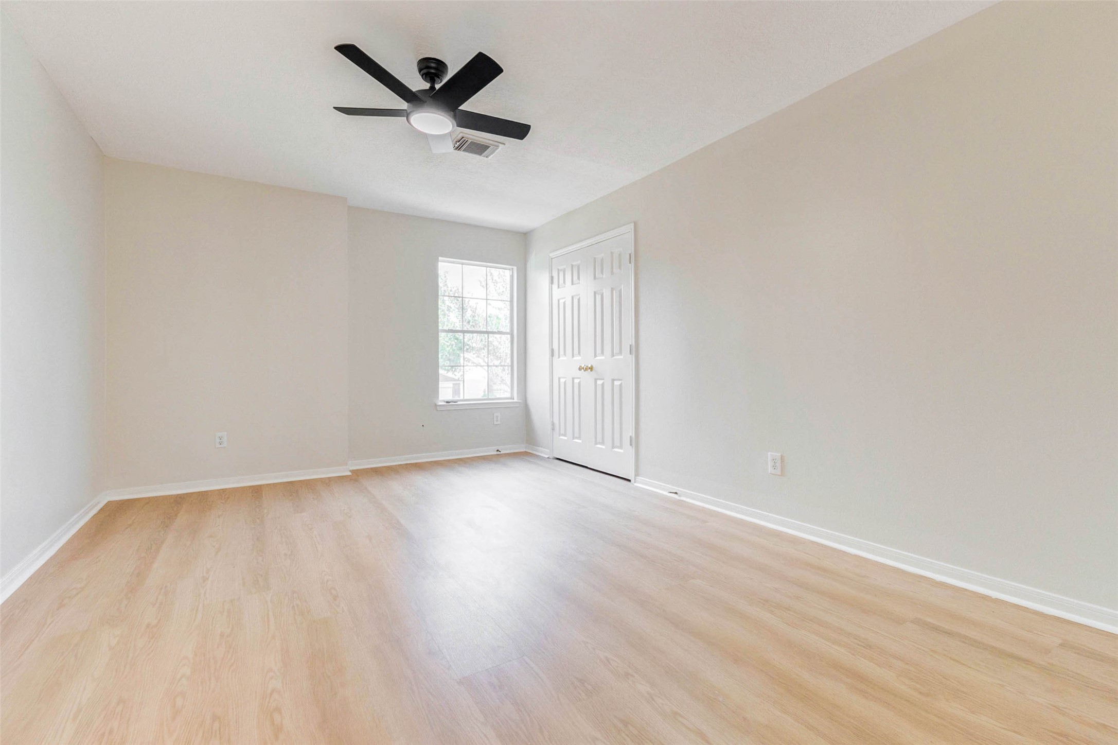 5318 Cilantro Lane Baytown, TX 77521 - Photo 29 of 45 an empty room with wooden floor and windows