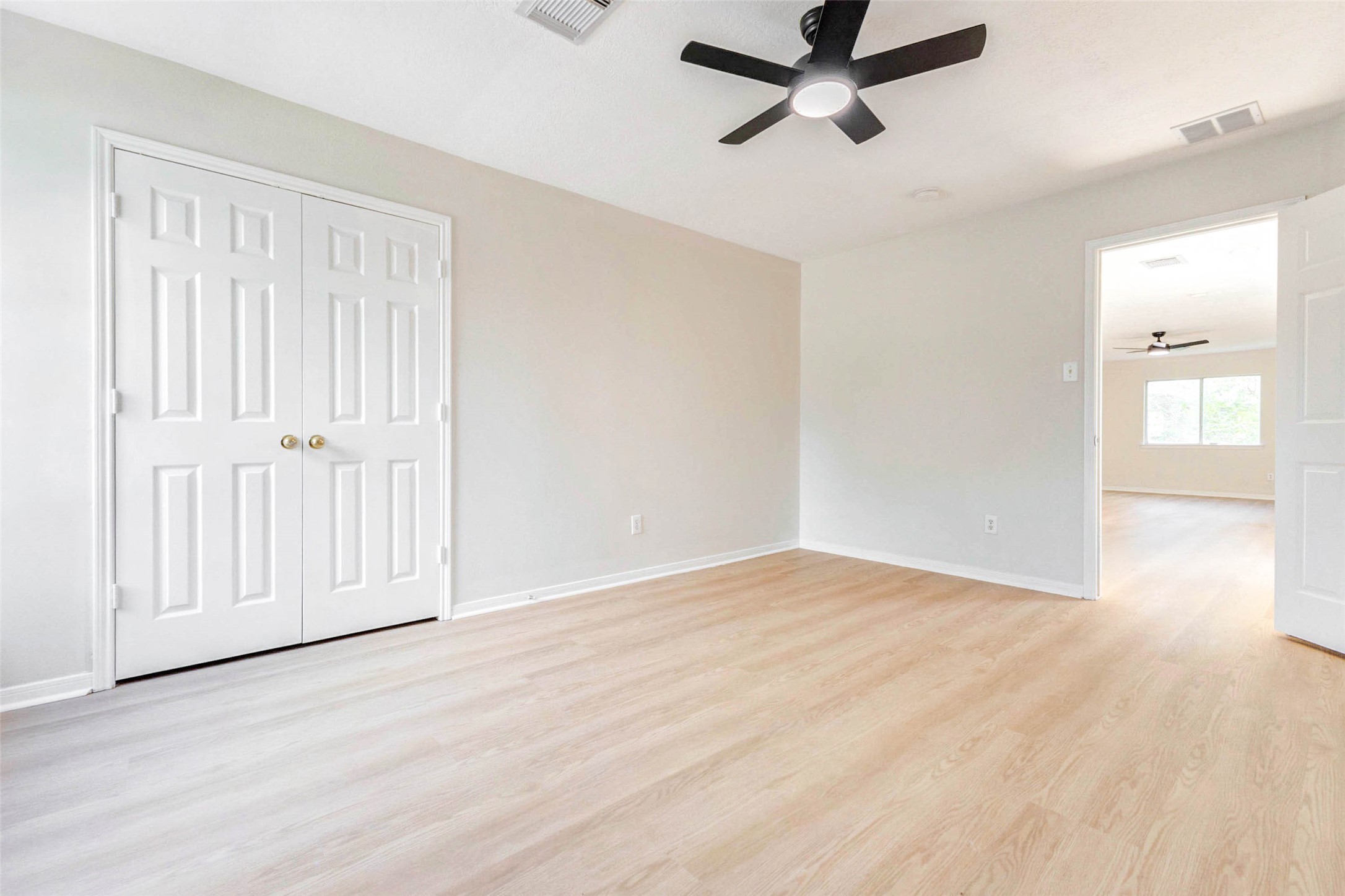 5318 Cilantro Lane Baytown, TX 77521 - Photo 30 of 45 an empty room with wooden floor and windows
