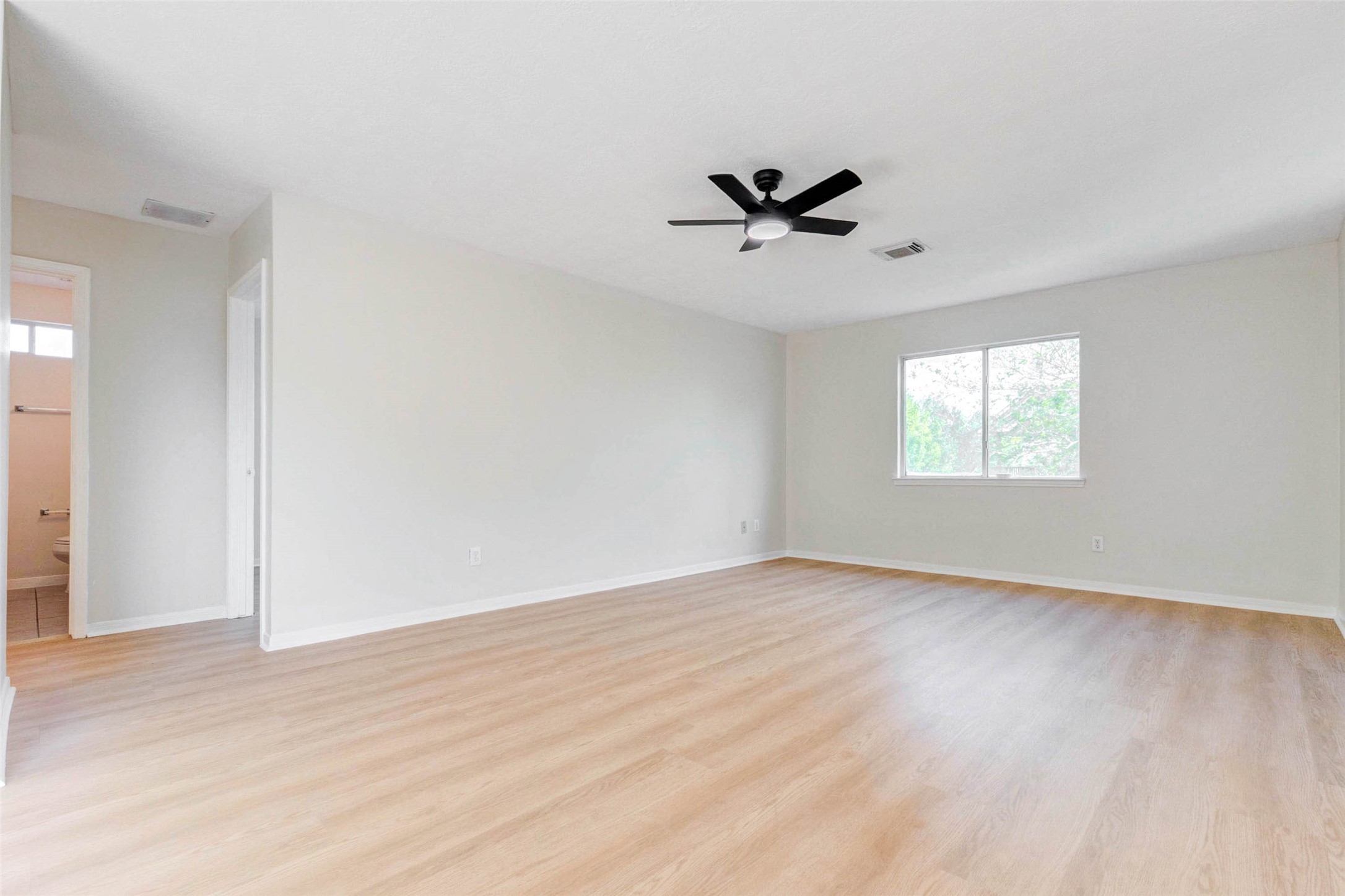 5318 Cilantro Lane Baytown, TX 77521 - Photo 32 of 45 a view of empty room with wooden floor and fan