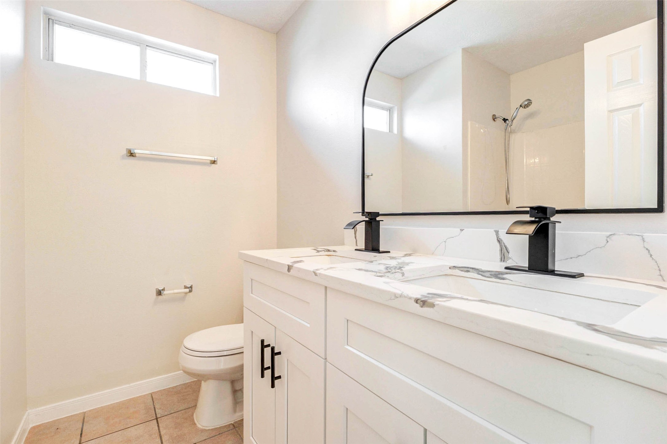 5318 Cilantro Lane Baytown, TX 77521 - Photo 37 of 45 a bathroom with a granite countertop sink a toilet and a mirror