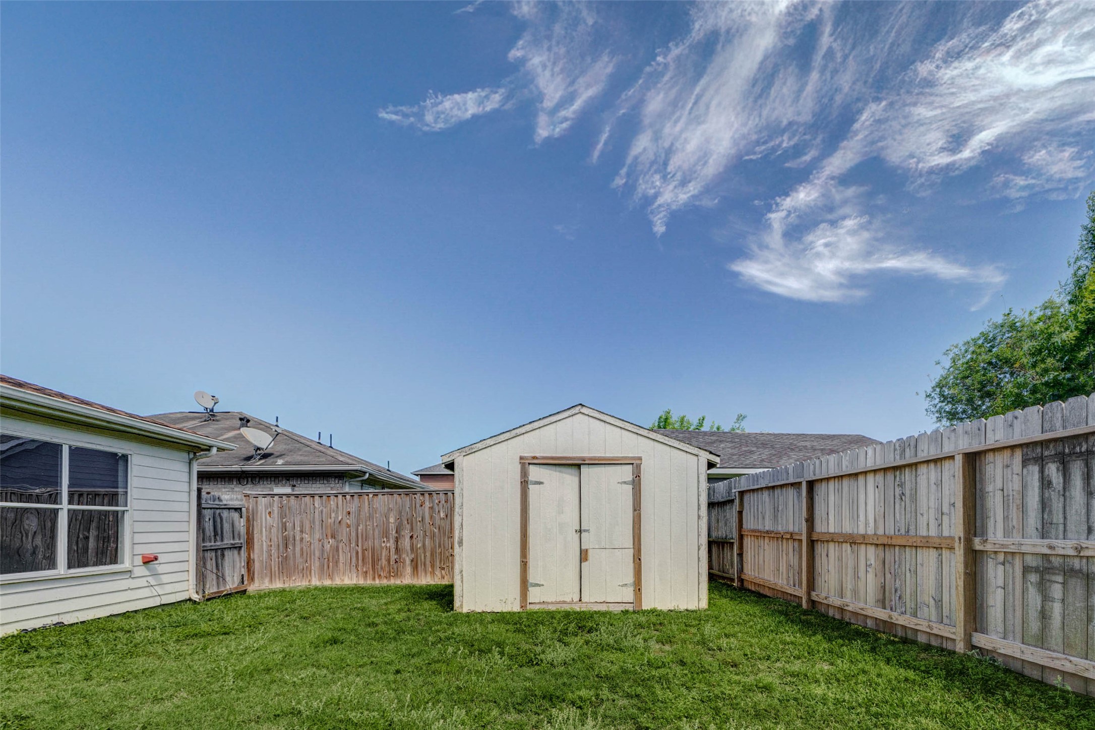 5318 Cilantro Lane Baytown, TX 77521 - Photo 43 of 45 a view of a backyard with wooden fence and a large tree