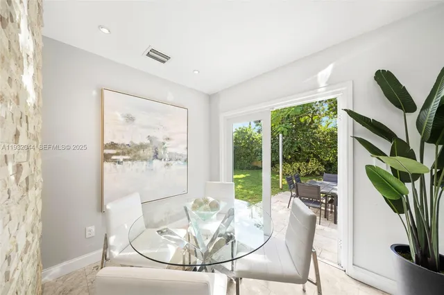 a view of a dining room with furniture wooden floor and a potted plant