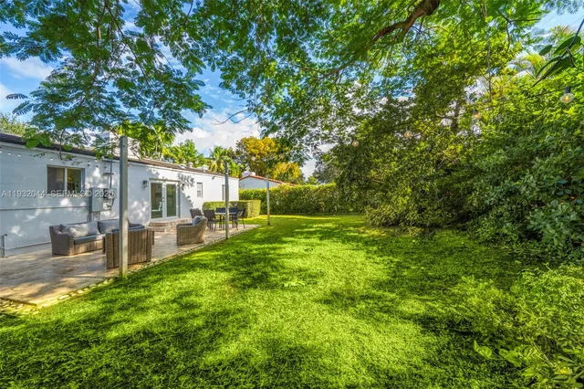 a view of a house with backyard porch and sitting area