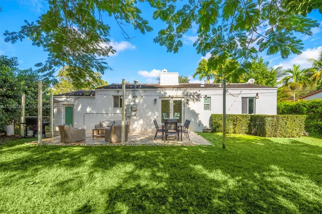 a patio with yard table and chairs