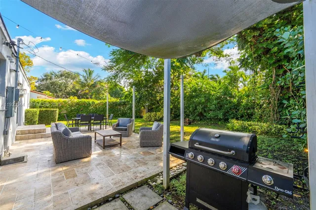 a view of a patio with couches and pool