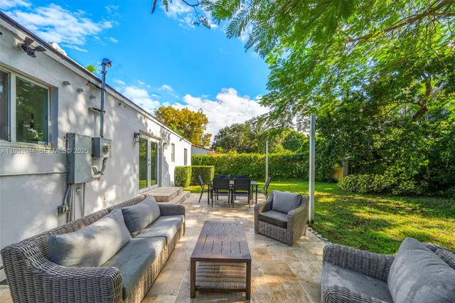 a view of swimming pool with garden and patio