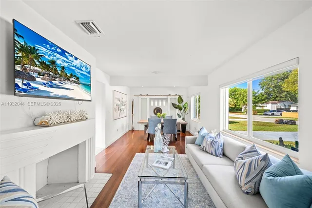 a view of a dining room with furniture window and wooden floor