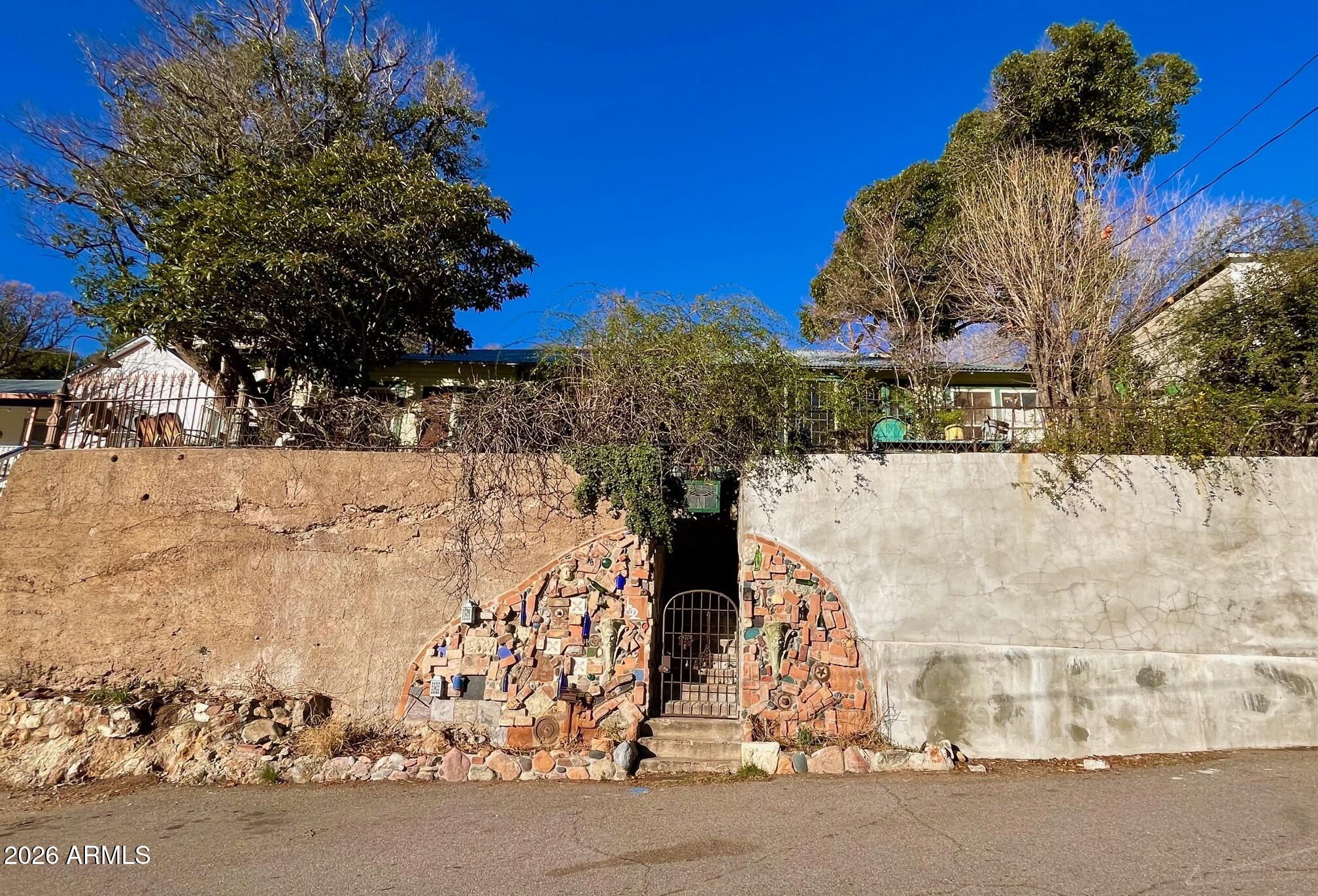 132 Opera Drive Bisbee, AZ 85603 - Photo 2 of 62 a view of entrance gate of house and trees