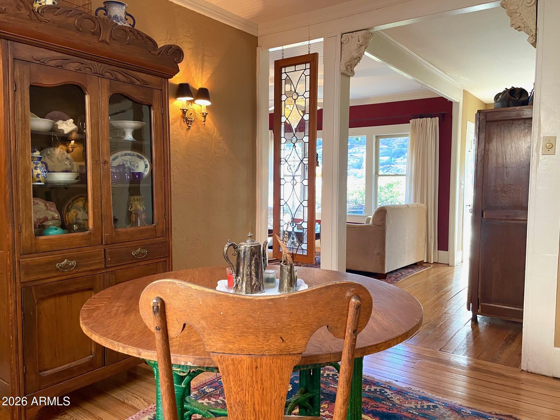 132 Opera Drive Bisbee, AZ 85603 - Photo 23 of 62 a view of a dining room with furniture and wooden floor