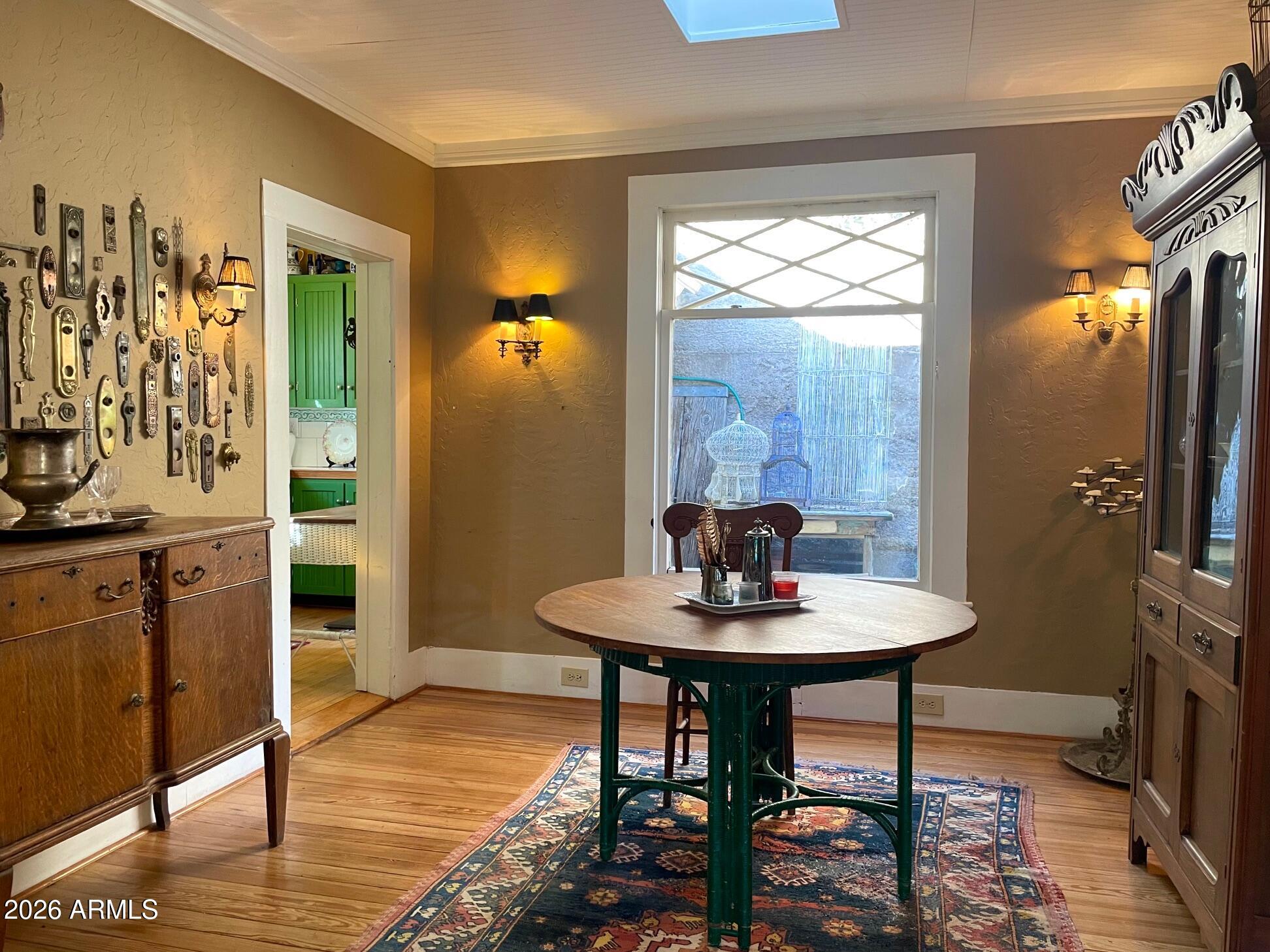 132 Opera Drive Bisbee, AZ 85603 - Photo 24 of 62 a view of a dining room with furniture window and wooden floor