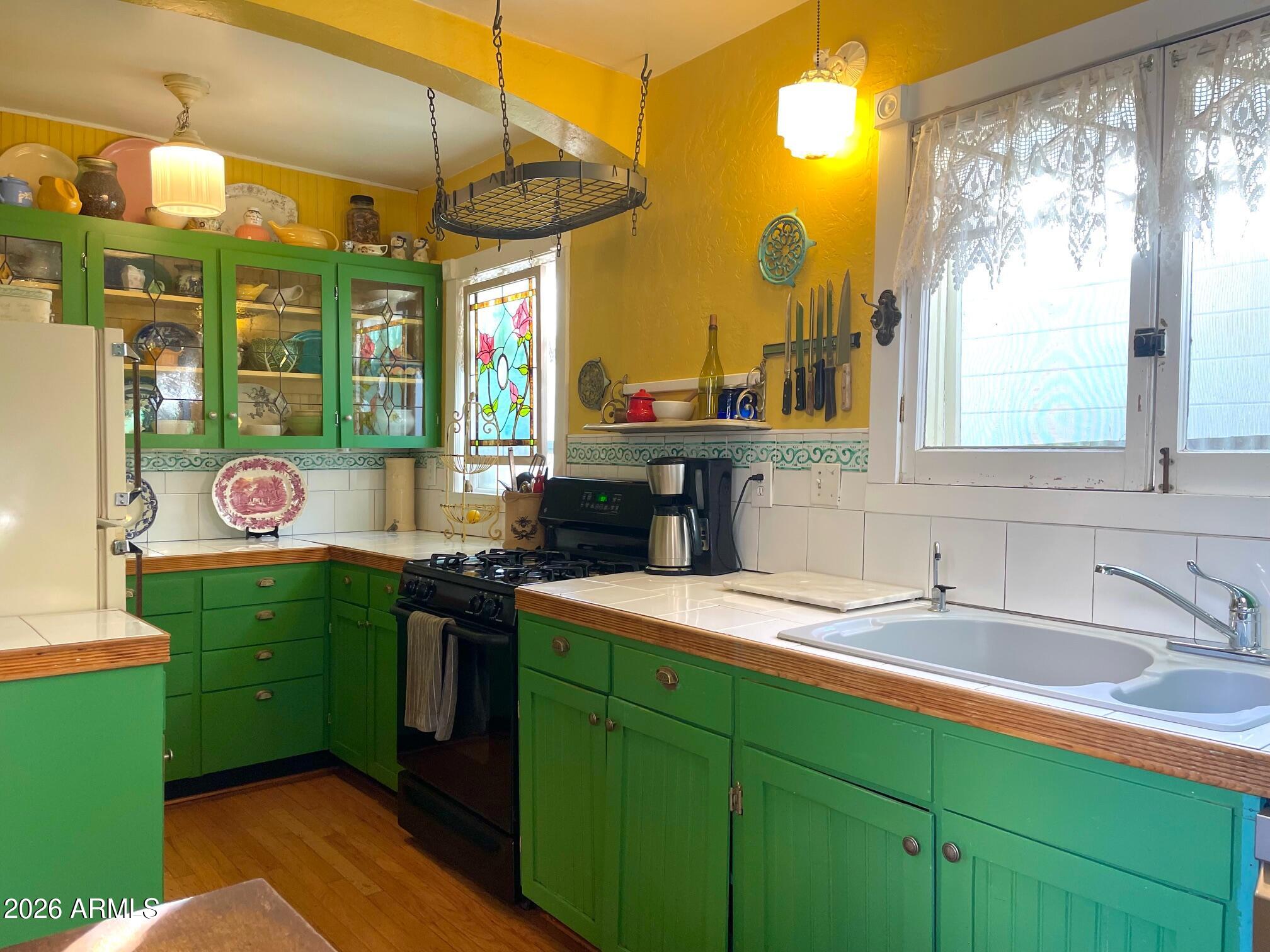 132 Opera Drive Bisbee, AZ 85603 - Photo 25 of 62 a kitchen that has a sink cabinets and a table