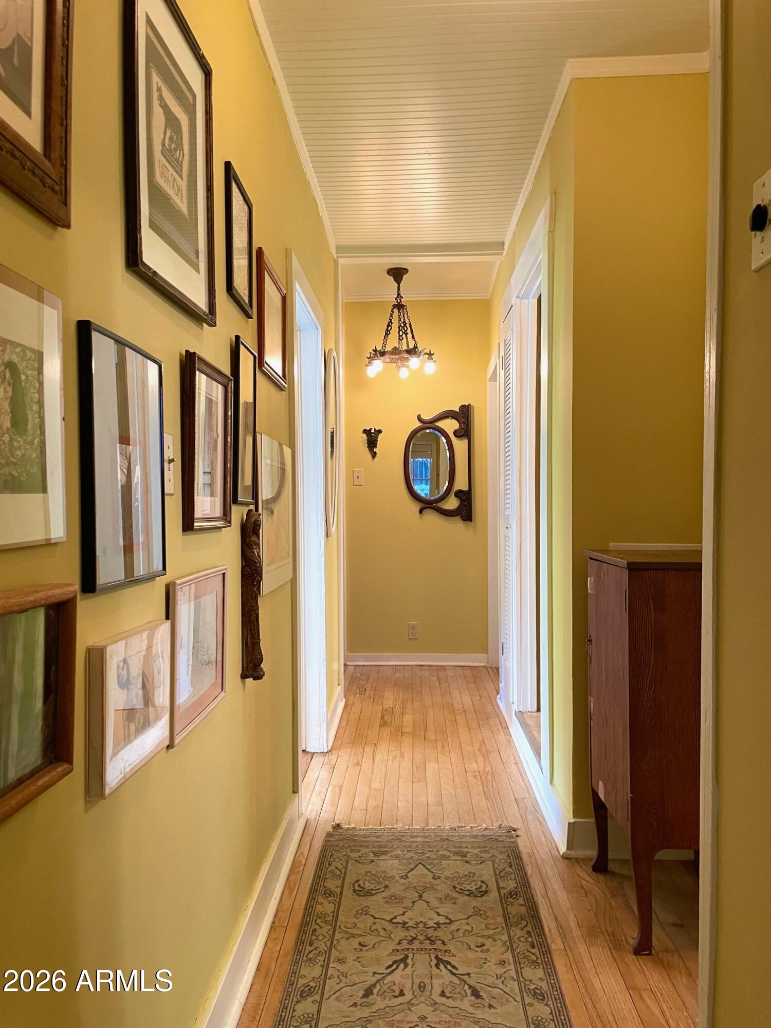 132 Opera Drive Bisbee, AZ 85603 - Photo 28 of 62 a view of a hallway with wooden floor and a bathroom