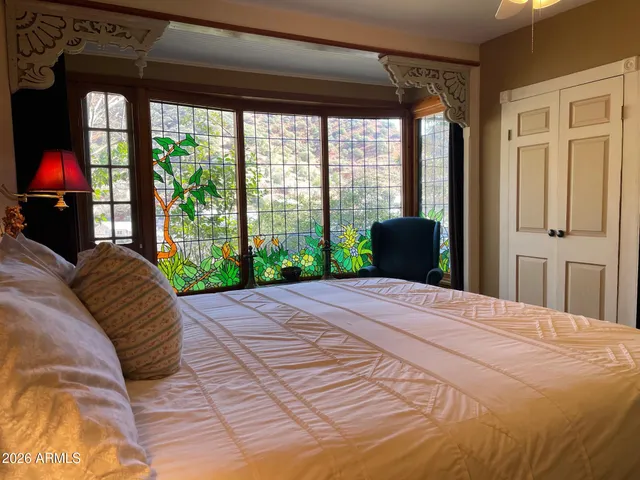 a bathroom with a granite countertop sink mirror vanity and toilet