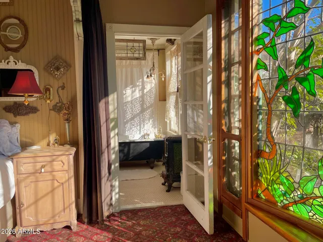 a bedroom with a bed and a mirror