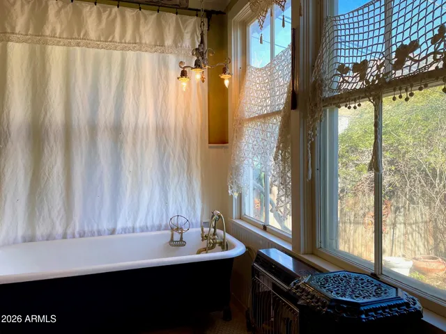 a bathroom with a granite countertop toilet sink and mirror