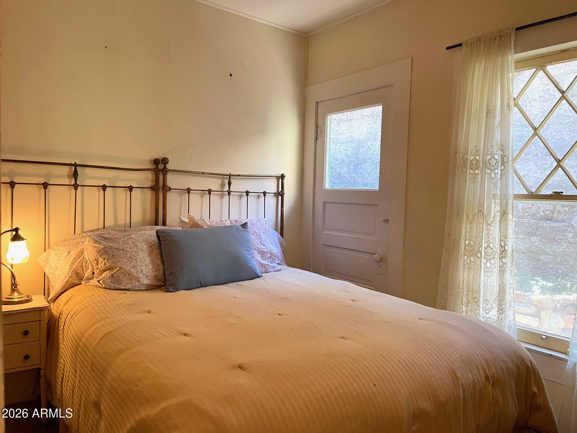 132 Opera Drive Bisbee, AZ 85603 - Photo 42 of 62 a bed sitting in a bedroom next to a window