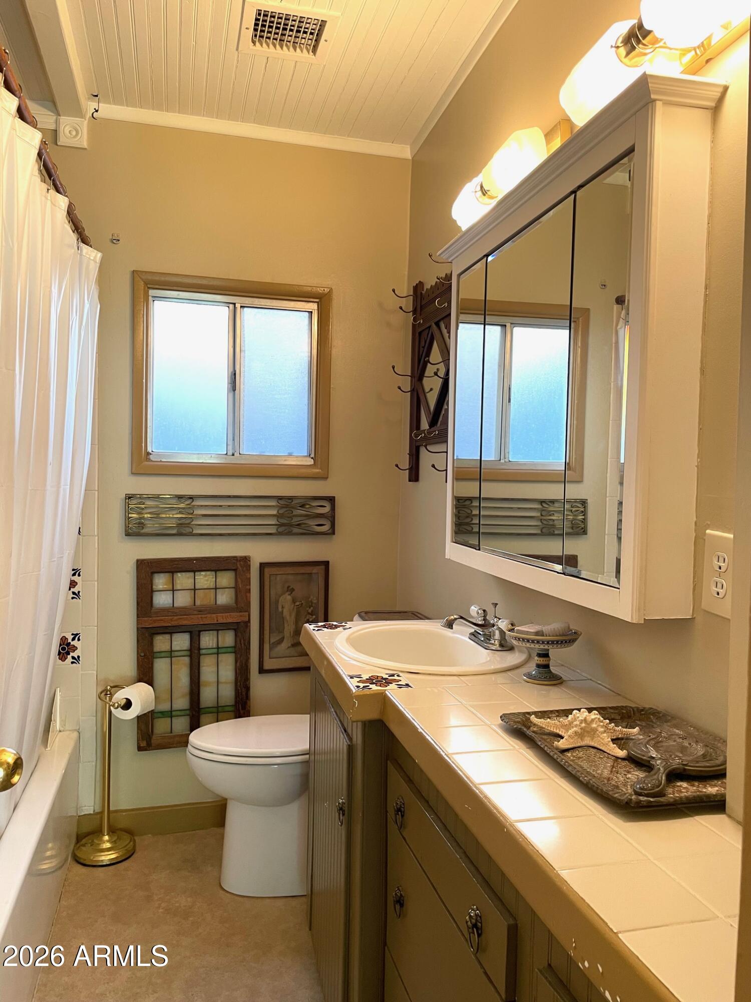 132 Opera Drive Bisbee, AZ 85603 - Photo 44 of 62 a bathroom with a granite countertop toilet sink and mirror