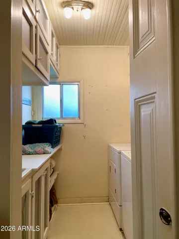 a view of a brick house with a large windows next to a yard