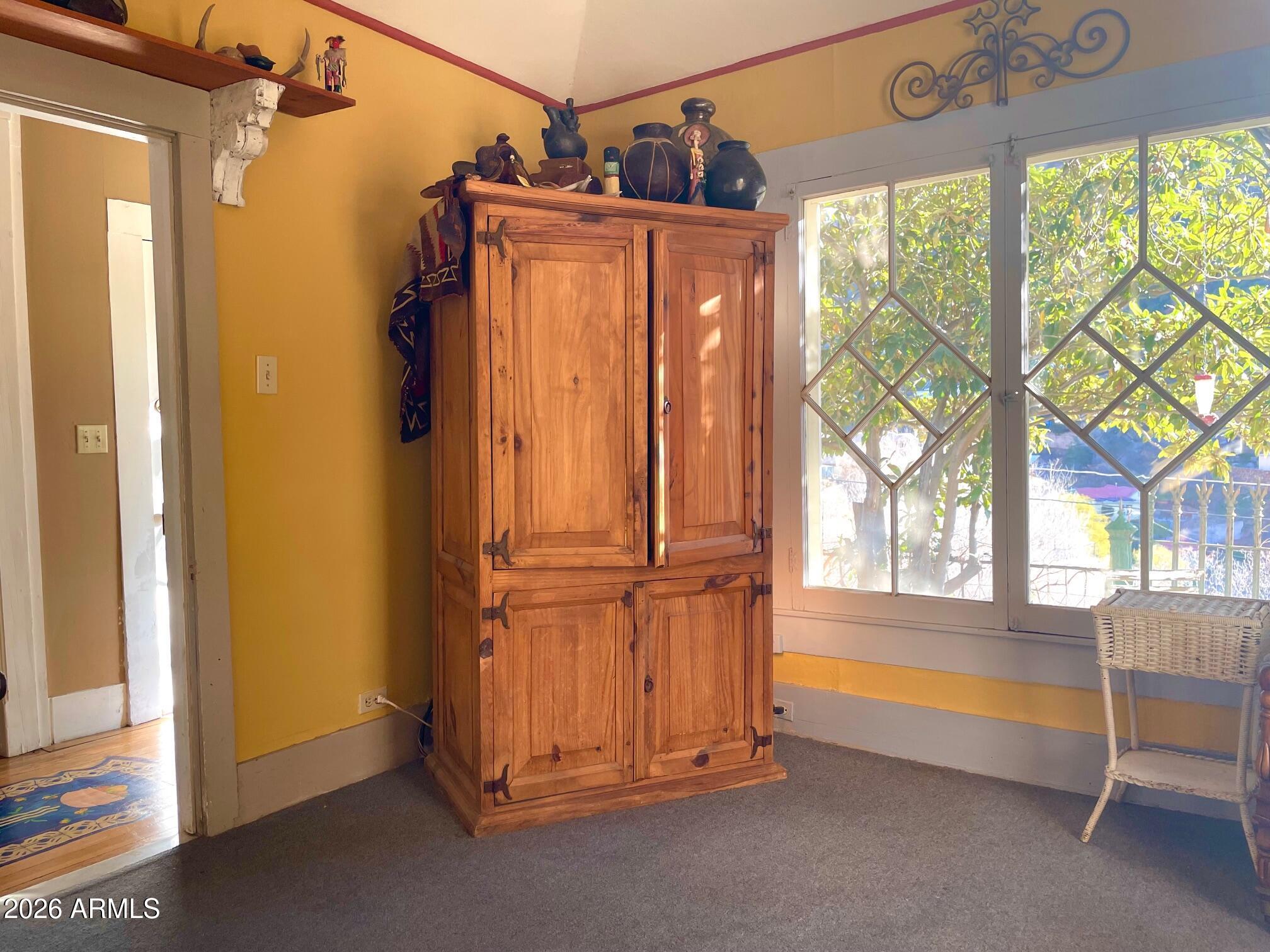 132 Opera Drive Bisbee, AZ 85603 - Photo 47 of 62 a view of an empty room with a fireplace and a large window