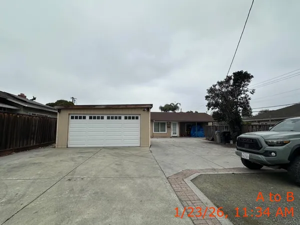 a view of a house with a yard and garage