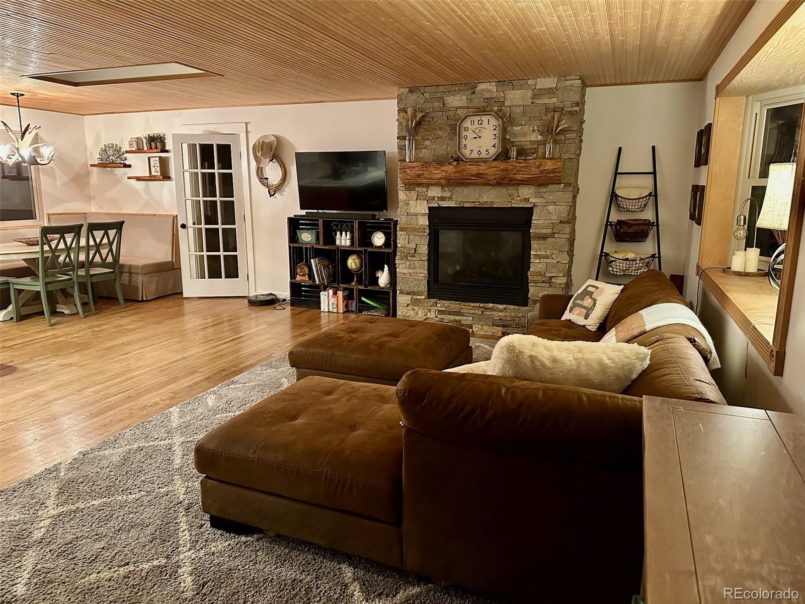 974 Wagon Trail Road Evergreen, CO 80439 - Photo 12 of 45 a living room with furniture and a flat screen tv