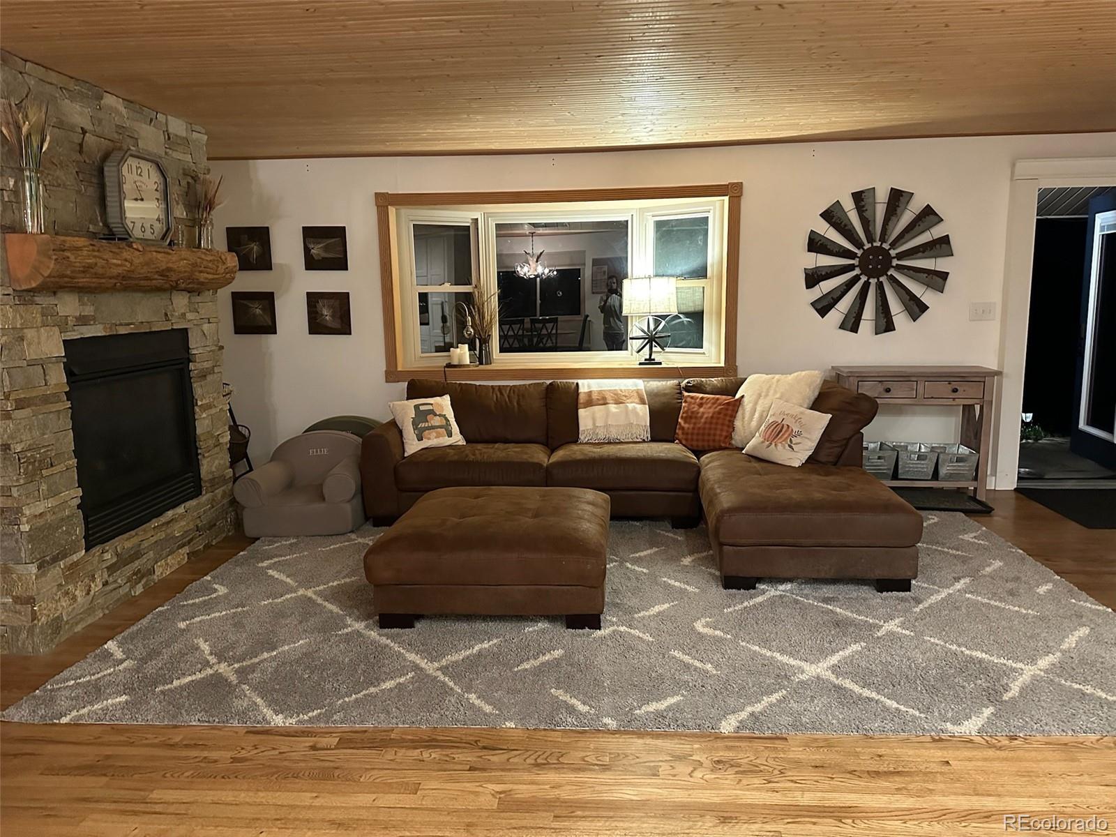 974 Wagon Trail Road Evergreen, CO 80439 - Photo 15 of 45 a living room with furniture and a fireplace