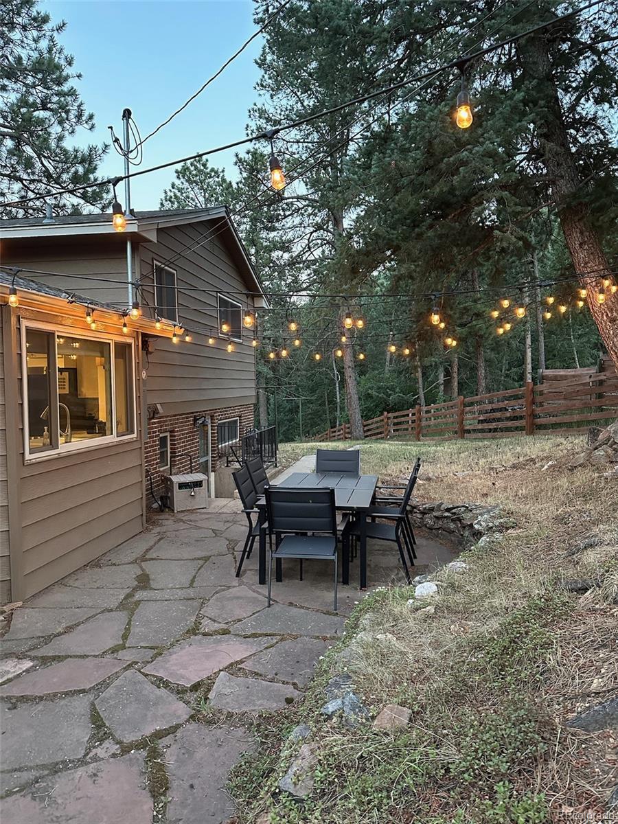 974 Wagon Trail Road Evergreen, CO 80439 - Photo 17 of 45 a view of a house with backyard and sitting area