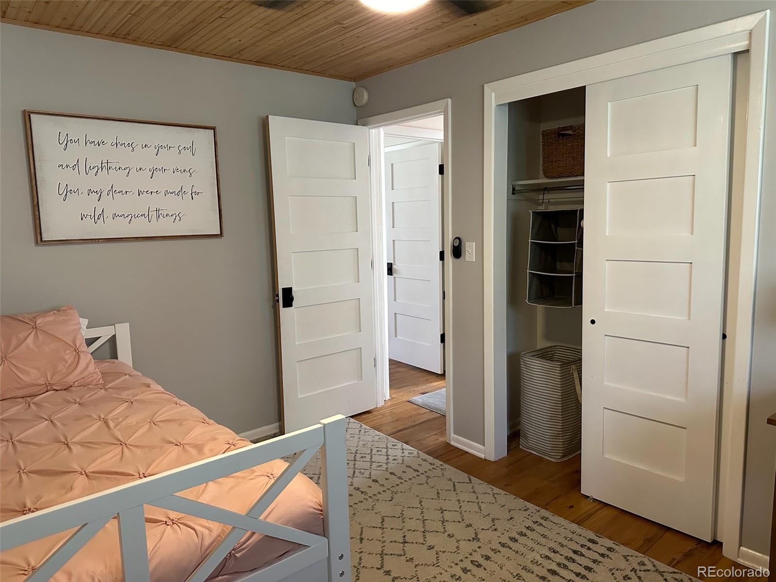 974 Wagon Trail Road Evergreen, CO 80439 - Photo 21 of 45 a bedroom with a bed and a walk in closet