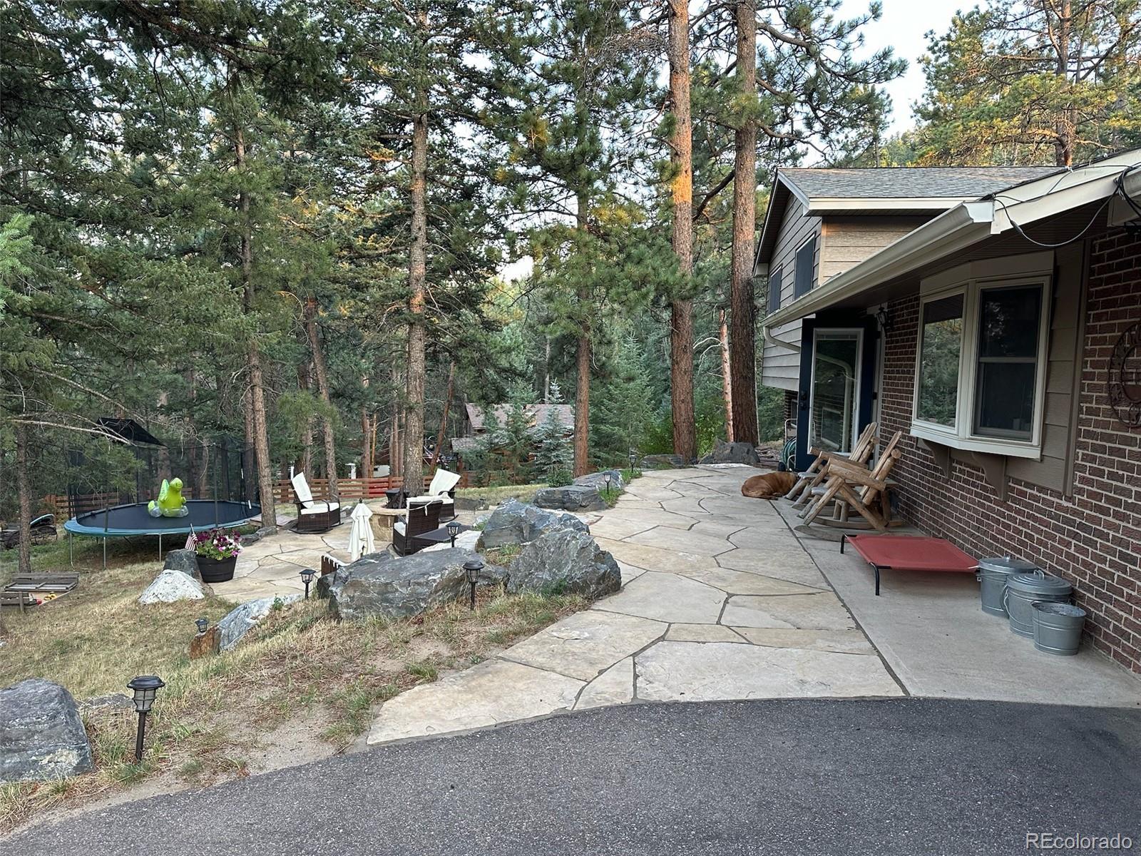 974 Wagon Trail Road Evergreen, CO 80439 - Photo 35 of 45 a view of backyard of house with outdoor seating