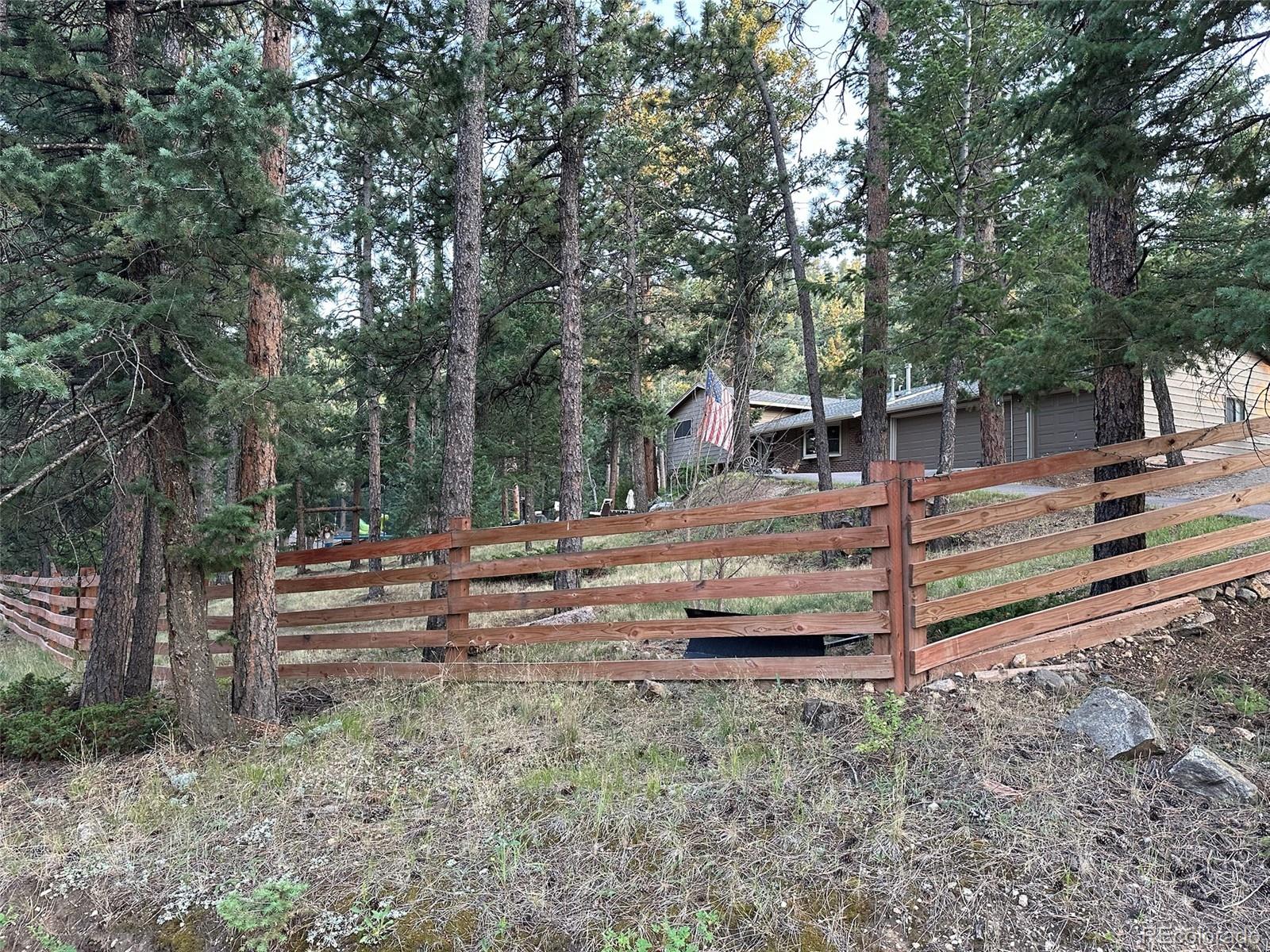 974 Wagon Trail Road Evergreen, CO 80439 - Photo 44 of 45 a backyard of a house with trees and stairs