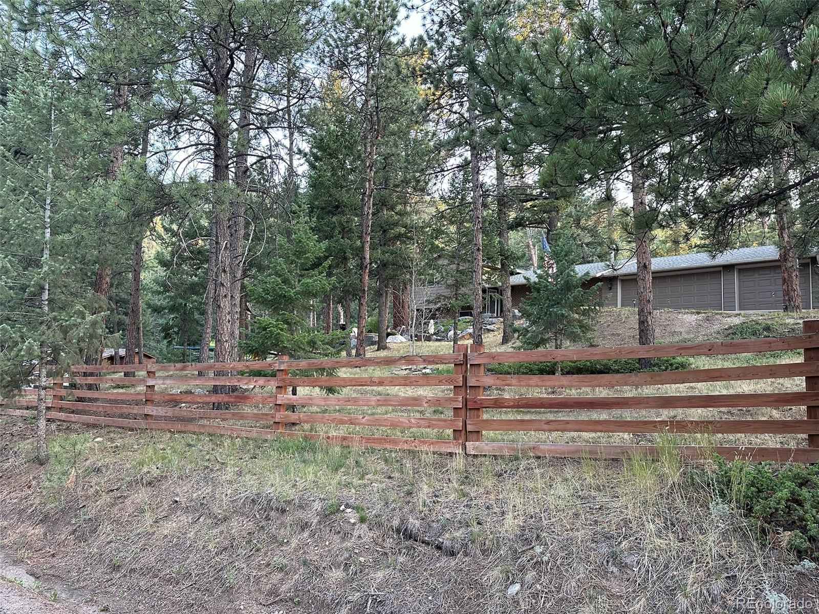 974 Wagon Trail Road Evergreen, CO 80439 - Photo 45 of 45 a view of a yard with tree s