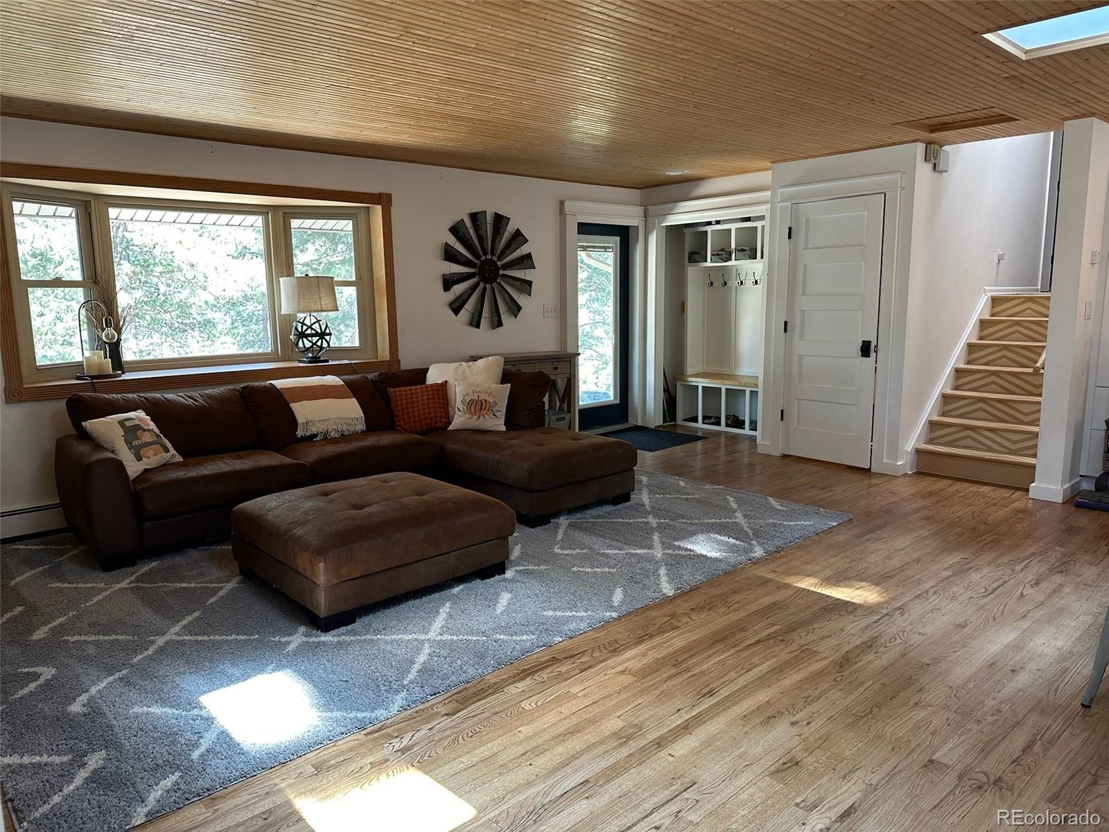 974 Wagon Trail Road Evergreen, CO 80439 - Photo 5 of 45 a living room with furniture and wooden floor