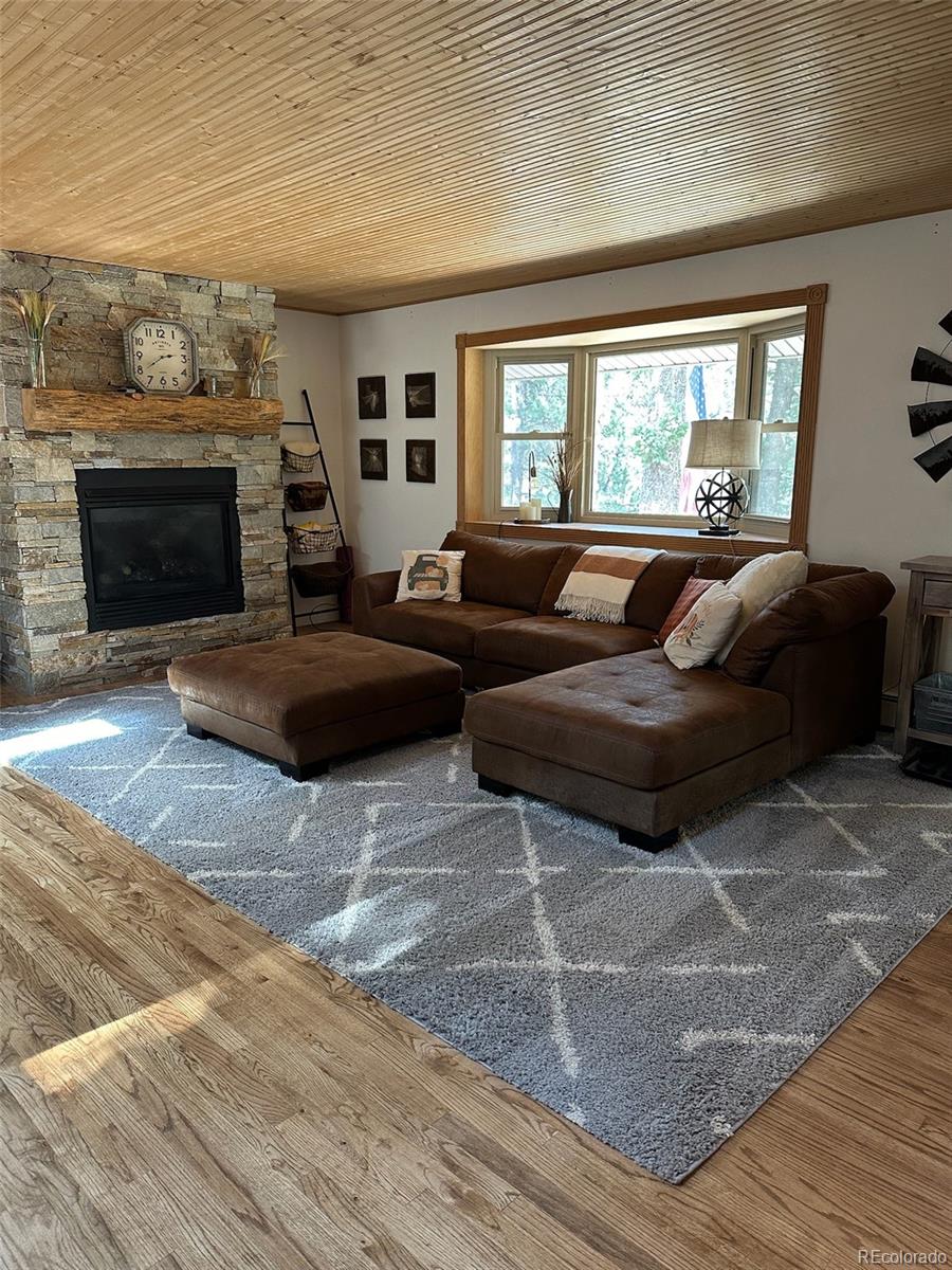 974 Wagon Trail Road Evergreen, CO 80439 - Photo 6 of 45 a living room with furniture and a fireplace