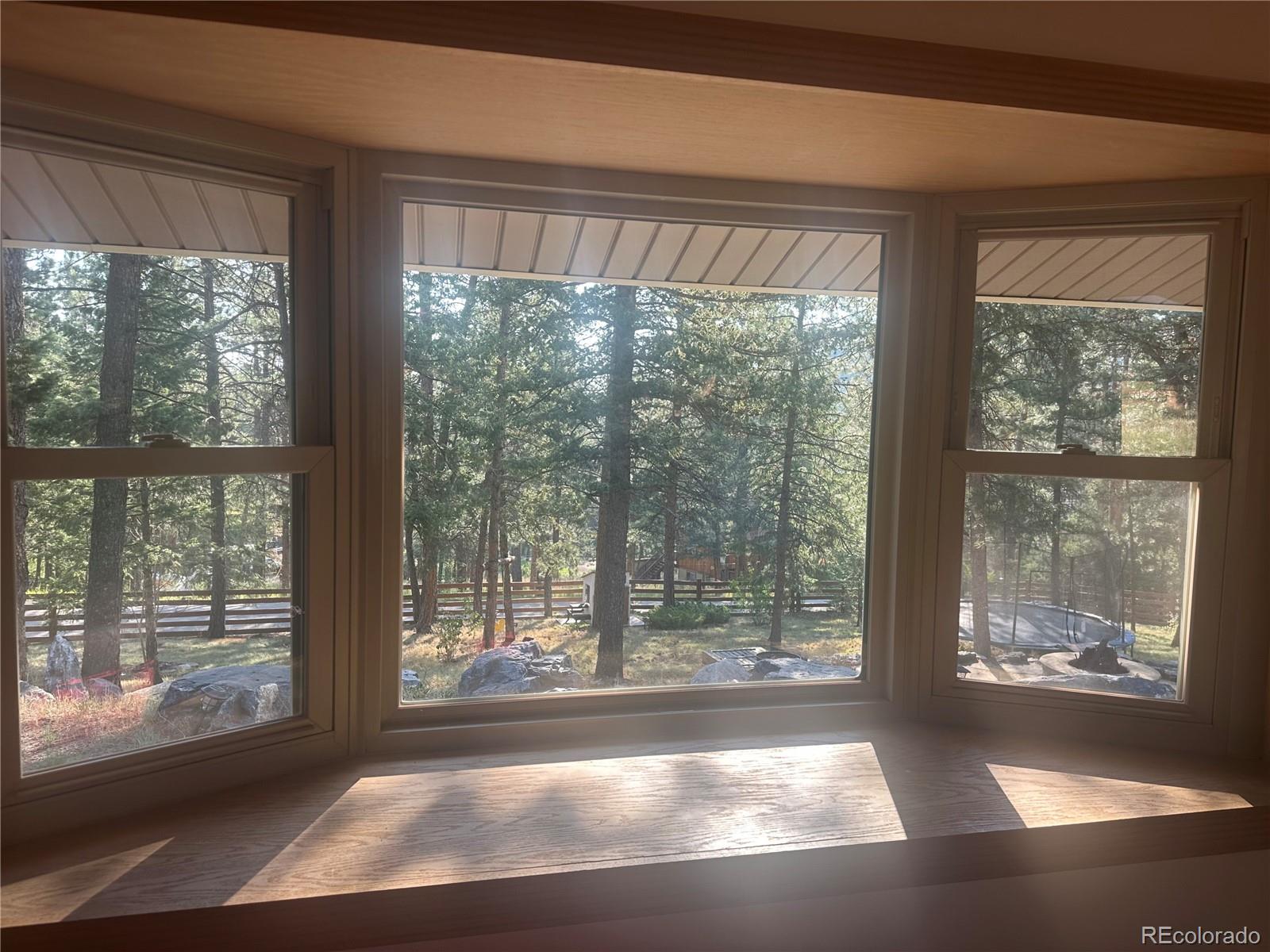 974 Wagon Trail Road Evergreen, CO 80439 - Photo 7 of 45 a view of empty room with windows