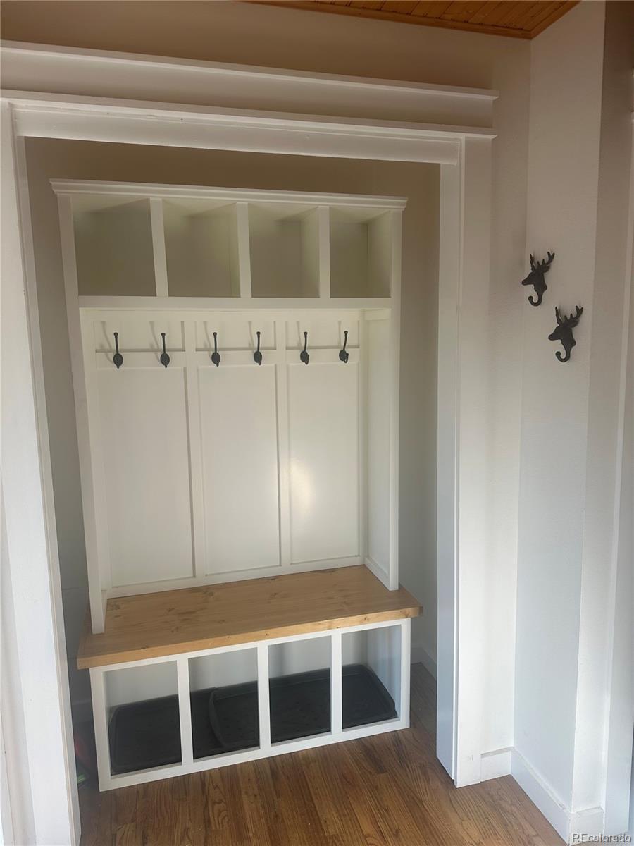 974 Wagon Trail Road Evergreen, CO 80439 - Photo 9 of 45 a view of an empty room with wooden floor and a cabinet