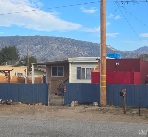 a view of a house with a yard and mountain