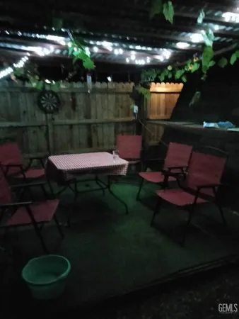 a view of a backyard with plants and a fireplace